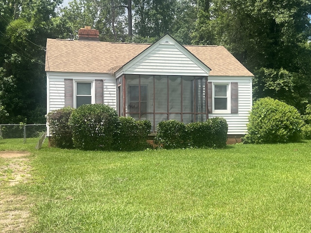 824 Ann St, Augusta, GA 30904 - view of front facade with a shingled roof, a sunroom, and a chimney