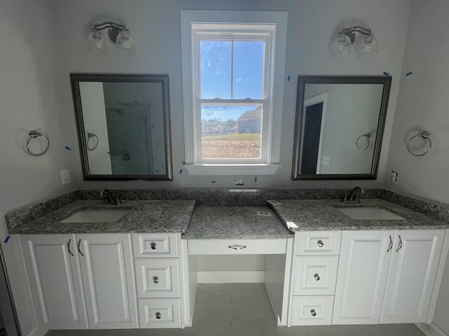 bathroom featuring tile patterned flooring and vanity