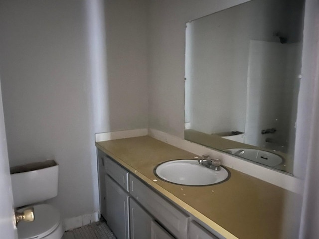 bathroom featuring tile patterned floors, vanity, and toilet