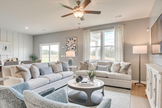 living room featuring plenty of natural light, light hardwood / wood-style floors, and ceiling fan