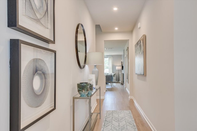 hall with light hardwood / wood-style floors