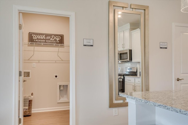 corridor featuring light hardwood / wood-style floors