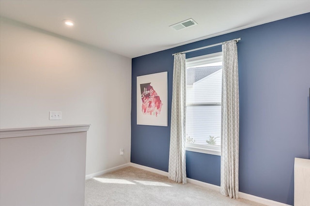 unfurnished room featuring light colored carpet