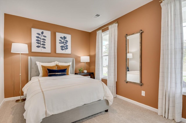 bedroom featuring light colored carpet