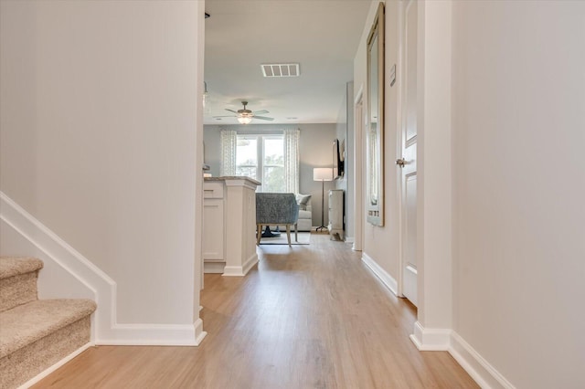 corridor with light hardwood / wood-style floors