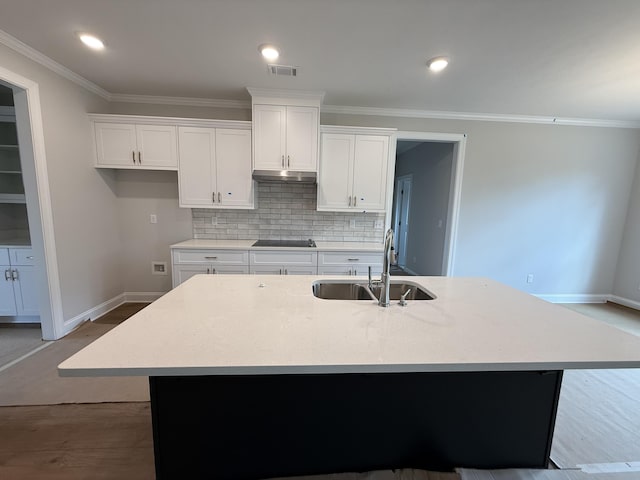 251 Prominence Dr, Grovetown, GA 30813 - kitchen with ornamental molding, white cabinets, a center island with sink, decorative backsplash, and light countertops