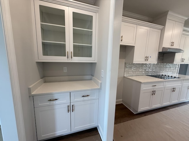 251 Prominence Dr, Grovetown, GA 30813 - kitchen with black electric cooktop, under cabinet range hood, light countertops, dark wood-type flooring, and tasteful backsplash