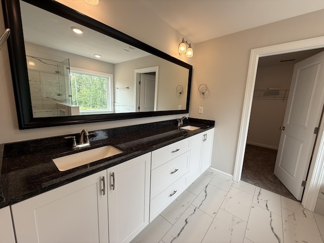 251 Prominence Dr, Grovetown, GA 30813 - bathroom featuring double vanity, marble finish floors, a tile shower, and a walk in closet