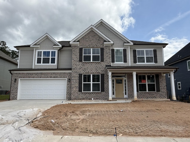 251 Prominence Dr, Grovetown, GA 30813 - craftsman-style house featuring brick siding, concrete driveway, a garage, and covered porch
