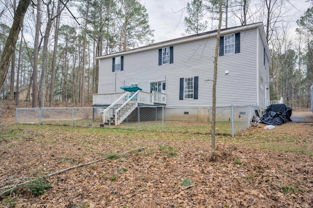 back of house featuring a wooden deck