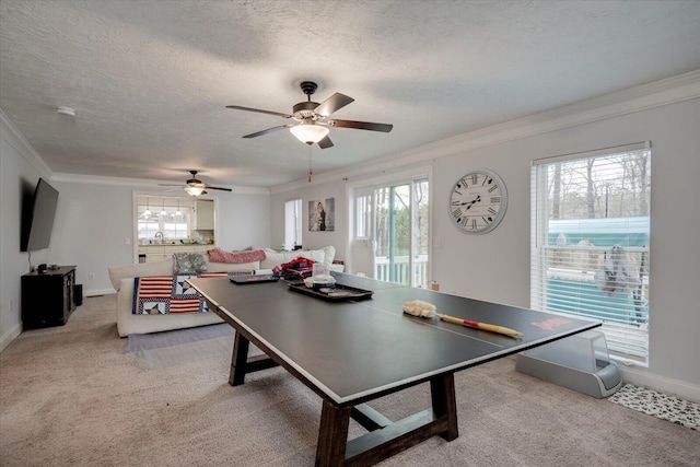 rec room featuring sink, crown molding, ceiling fan, a textured ceiling, and light colored carpet