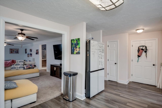 living room featuring hardwood / wood-style floors, a textured ceiling, and ceiling fan