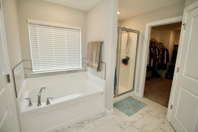 144 Caroleton Dr, Grovetown, GA 30813 - bathroom featuring a stall shower, marble finish floors, a bath, and a walk in closet