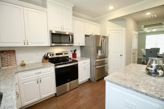 144 Caroleton Dr, Grovetown, GA 30813 - kitchen with appliances with stainless steel finishes, dark wood-style flooring, white cabinets, crown molding, and tasteful backsplash