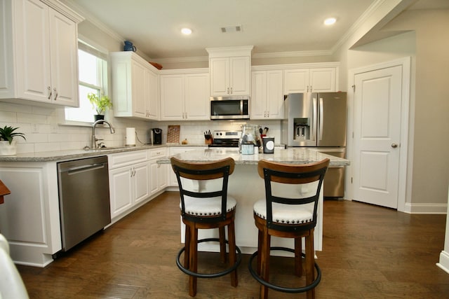 144 Caroleton Dr, Grovetown, GA 30813 - kitchen featuring appliances with stainless steel finishes, a sink, white cabinetry, ornamental molding, and tasteful backsplash