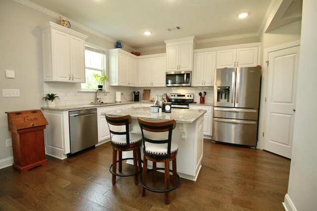 144 Caroleton Dr, Grovetown, GA 30813 - kitchen with appliances with stainless steel finishes, a sink, white cabinetry, decorative backsplash, and crown molding