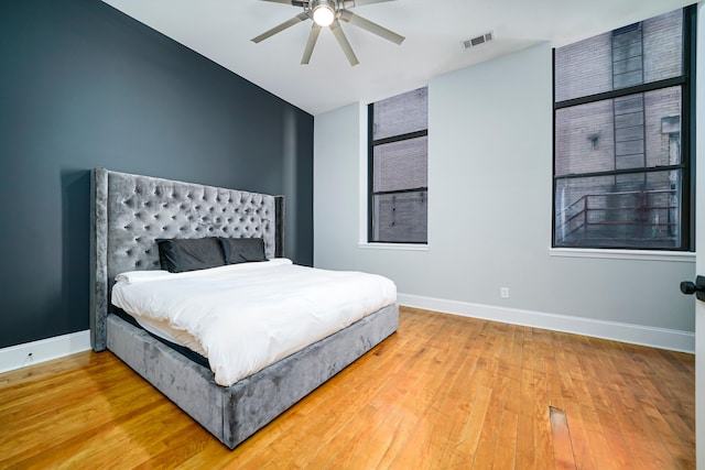 bedroom with ceiling fan and hardwood / wood-style flooring