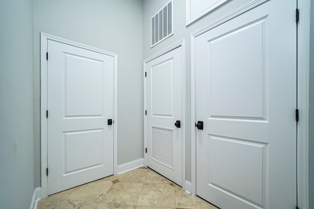 entryway with light tile patterned flooring