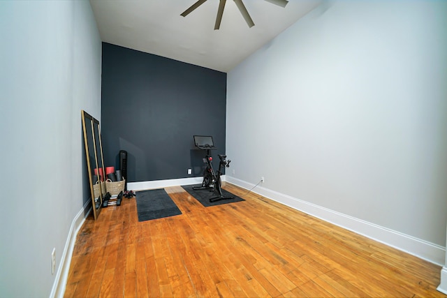 workout room with ceiling fan and hardwood / wood-style flooring