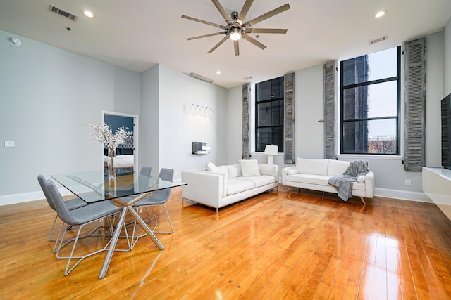 living room featuring hardwood / wood-style floors and ceiling fan