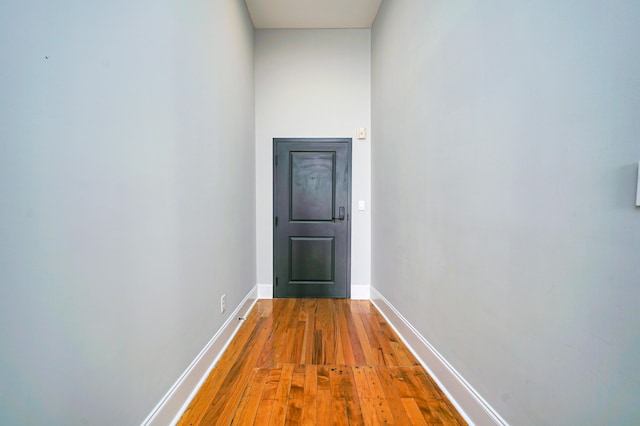 corridor with hardwood / wood-style floors