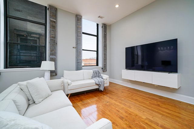 living room featuring hardwood / wood-style floors and lofted ceiling