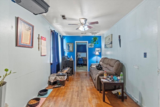 living room with ceiling fan and wood-type flooring