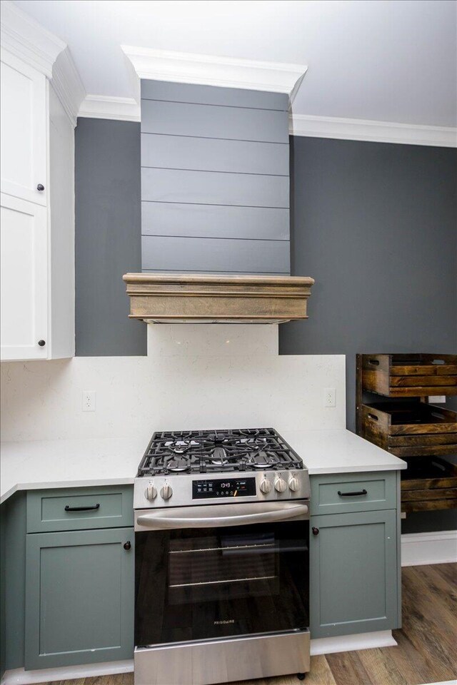 925 Beman St, Augusta, GA 30904 - kitchen with gas stove, ornamental molding, light wood finished floors, light countertops, and white cabinets
