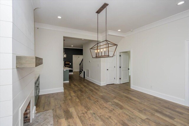 925 Beman St, Augusta, GA 30904 - unfurnished living room featuring wood finished floors, recessed lighting, baseboards, crown molding, and a chandelier
