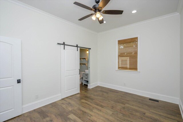 925 Beman St, Augusta, GA 30904 - unfurnished bedroom featuring wood finished floors, a barn door, crown molding, baseboards, and recessed lighting