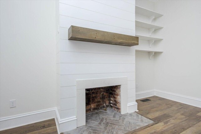 925 Beman St, Augusta, GA 30904 - detailed view of a fireplace with flush hearth, wood finished floors, and baseboards