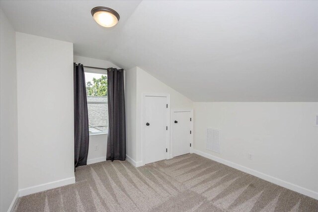 925 Beman St, Augusta, GA 30904 - additional living space with lofted ceiling, light carpet, and baseboards