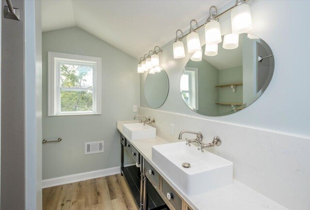 925 Beman St, Augusta, GA 30904 - full bathroom featuring lofted ceiling, double vanity, and wood finished floors