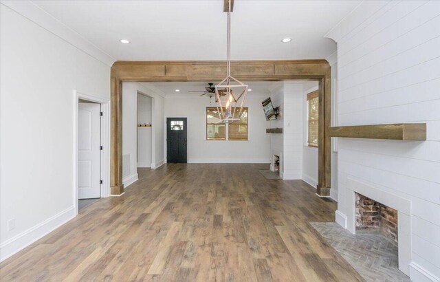 925 Beman St, Augusta, GA 30904 - unfurnished dining area with a fireplace, crown molding, ceiling fan, wood finished floors, and baseboards