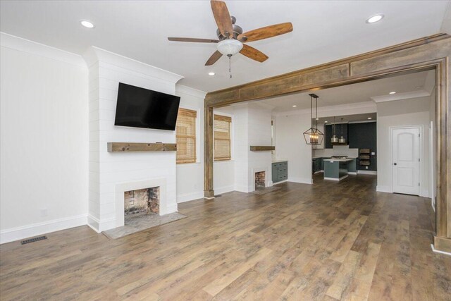 925 Beman St, Augusta, GA 30904 - unfurnished living room featuring a fireplace, a ceiling fan, crown molding, wood finished floors, and baseboards