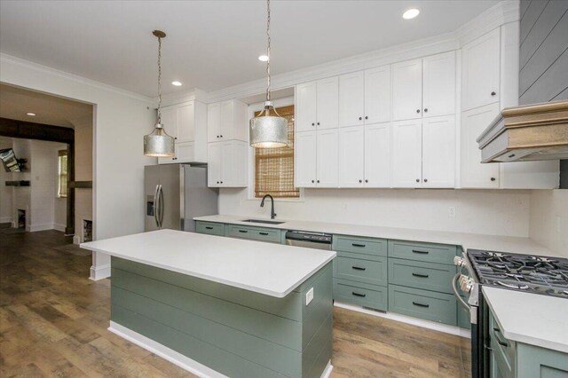 925 Beman St, Augusta, GA 30904 - kitchen featuring stainless steel appliances, green cabinetry, white cabinetry, a sink, and crown molding