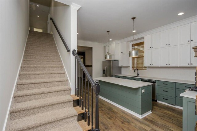 925 Beman St, Augusta, GA 30904 - kitchen featuring appliances with stainless steel finishes, green cabinetry, white cabinetry, light countertops, and crown molding