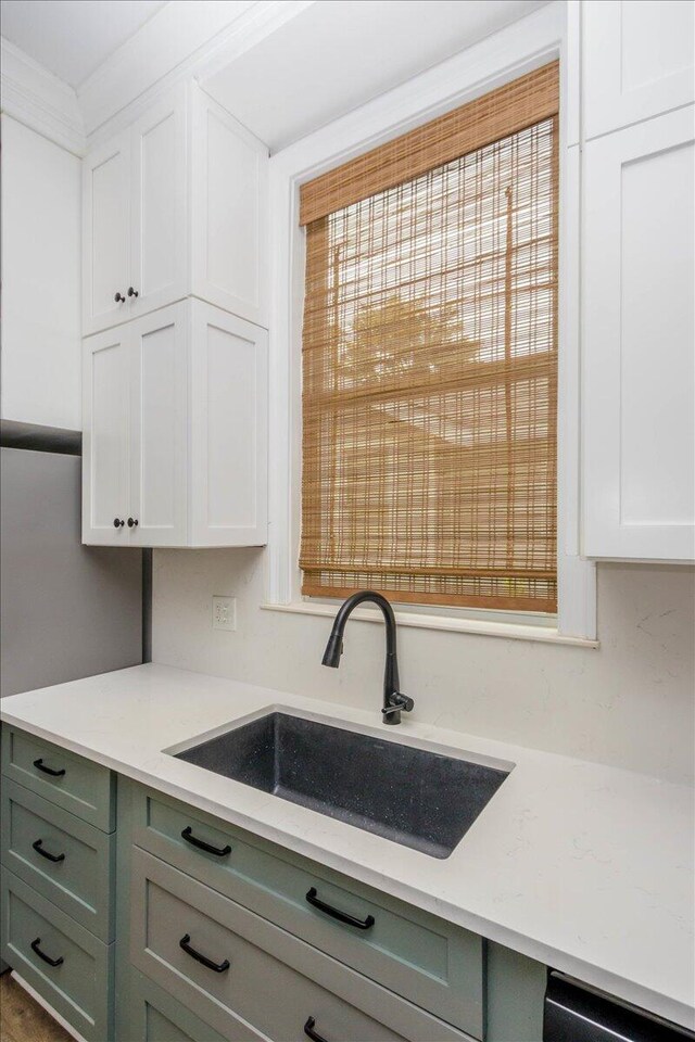 925 Beman St, Augusta, GA 30904 - kitchen with a sink, dishwashing machine, white cabinetry, and light stone countertops