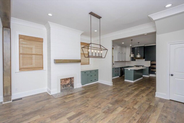 925 Beman St, Augusta, GA 30904 - kitchen with a kitchen island, baseboards, light countertops, crown molding, and dark wood-style flooring