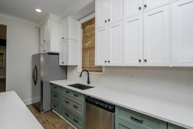 925 Beman St, Augusta, GA 30904 - kitchen featuring appliances with stainless steel finishes, a sink, light countertops, ornamental molding, and white cabinetry