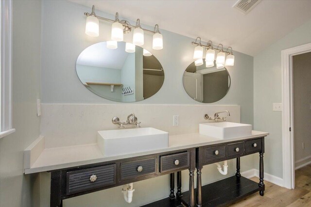 925 Beman St, Augusta, GA 30904 - full bathroom featuring double vanity, wood finished floors, and lofted ceiling