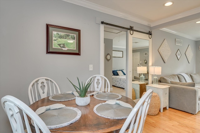 208 Elm St, Grovetown, GA 30813 - dining room with light wood-type flooring, a barn door, ornamental molding, and recessed lighting