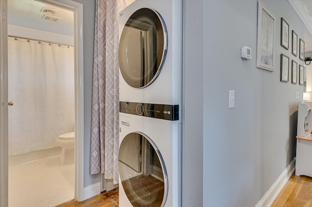 208 Elm St, Grovetown, GA 30813 - laundry area featuring stacked washer / drying machine, light wood-style floors, and baseboards