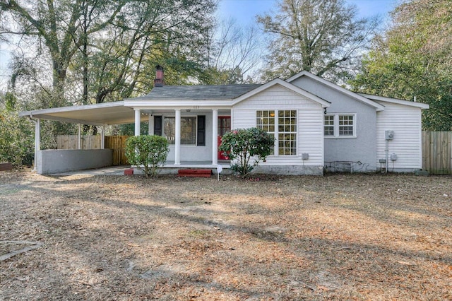 view of front of home with a carport and a porch