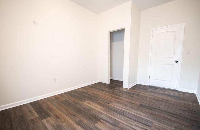 unfurnished bedroom with a closet and dark wood-type flooring