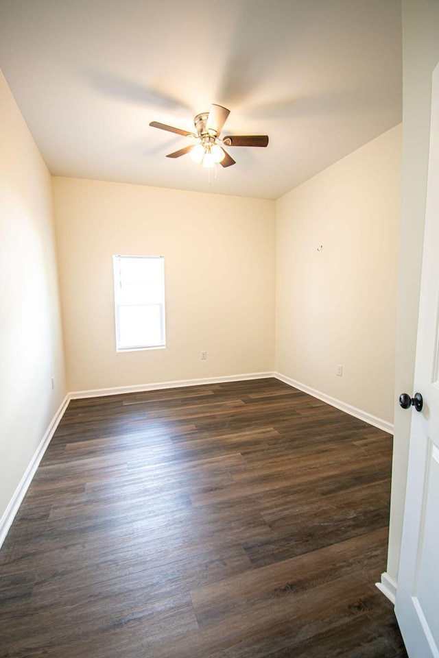 unfurnished room featuring ceiling fan and dark wood-type flooring