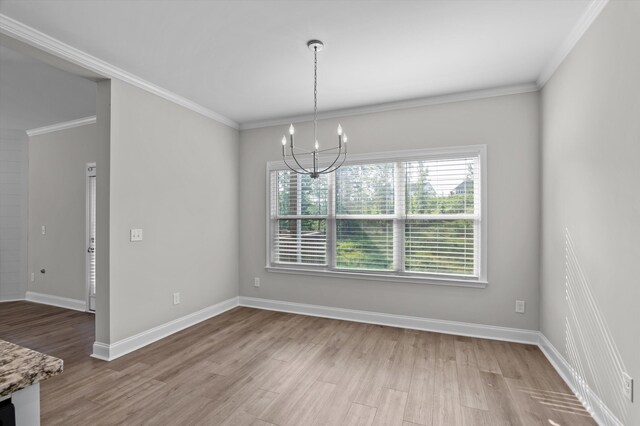 647 Bunchgrass St, Evans, GA 30809 - unfurnished dining area with a chandelier, wood finished floors, baseboards, and crown molding