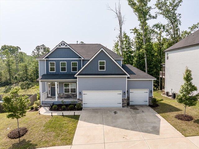647 Bunchgrass St, Evans, GA 30809 - craftsman-style house featuring covered porch, a front lawn, driveway, and stone siding