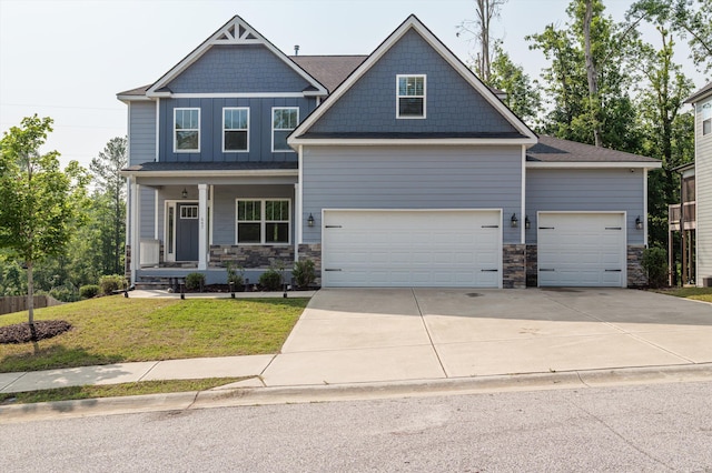 647 Bunchgrass St, Evans, GA 30809 - craftsman-style home featuring stone siding, an attached garage, driveway, a front yard, and a porch