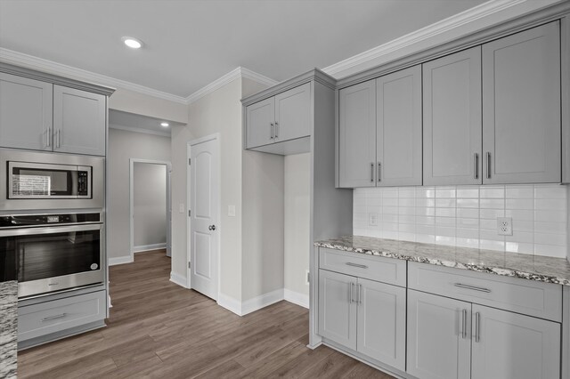 647 Bunchgrass St, Evans, GA 30809 - kitchen with appliances with stainless steel finishes, gray cabinets, baseboards, crown molding, and tasteful backsplash